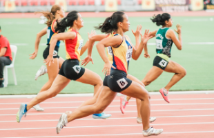 Female athletes running on sports track 
