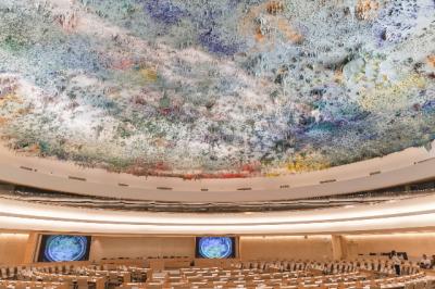 Image of the inside of the Human Rights Council room and its colourful textured ceiling. 