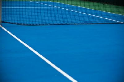 Image of ground of empty tennis court. 