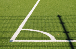 Corner of grass football pitch