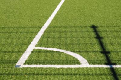 Corner of grass football pitch.