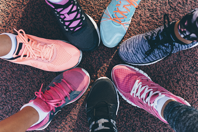 Birds-eye view of females trainers all pointing together in a circle. 