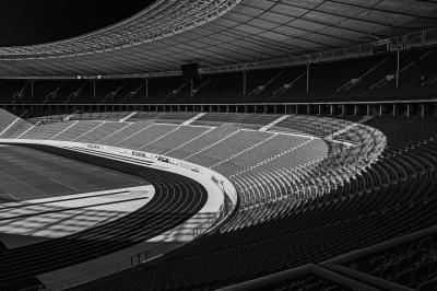 Black and white image of inside an empty sports stadium. 